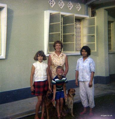 Ann, Jean and Alastair Young
1968 Jalan Indera Putra, Johore Bahru Ann, Jean and Alastair Young, 'This is Mai our Amah with us in her working gear' with Bengo & Patch

