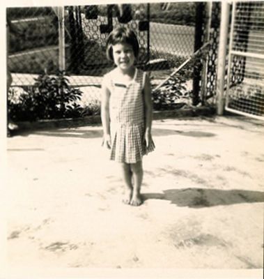 Photo of me as a young girl wearing the RAF Seletar infant school  uniform - Green and white check summer dress
Keywords: Sandra Chidgey