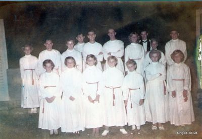 RAF Tengah St. Michaels Church Choir 1955/56.
Thomas Gilbert was stationed at Tengah 1954/1956 and ran the Cub Pack and the Church Choir. The photo is of St. Michaels Church Choir 1955/56.  The Chaplain was  the Revd Sqdn Ldr Derek Brookes.
Michael S. Arnold wrote to say. "I think Pat Midgley is front right but I am pretty sure that the girl on the back left is Joan Littlewood and it was her house that the jet crashed into in early 56, she escaped by jumping in to a monsoon ditch."
Keywords: Thomas Gilbert;RAF Tengah;St. Michaels;Church Choir