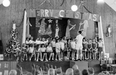 Here's a picture from a Christmas 1968 concert
Here's a picture from a Christmas 1968 concert, with Gwyn Jones conducting the choir. It's a good view of the stage, which was later used as the centre of the school library. My recorder group sits, poised for action
Keywords: Bill Johnston;Wessex Junior;Pasir Panjang Junior;School;Christmas;1968;Gwyn Jones