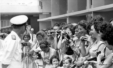 Visit by Prince Philip the Duke of Edinburgh to St. John's in February 1965.
shows Joanne Smith (teacher) taking a picture, daughter Amanda looking pensively.
Keywords: St. John&#039;St. Johns;Prince Philip;1965;Duke of Edinburgh;Joanne Smith