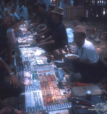 Jewellery
My mother took this photo of the jewellery sellers somewhere down in Singapore town. 
Keywords: Lou Watkins