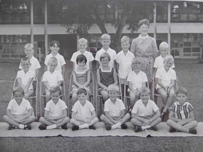 My brother James is Fourth from the left with his school teacher standing at the back.

One morning I ventured outside of my class room during my break. With his arms stretched out, my brother James was running around the school playing field with his friends shouting out the words, " ratta - tat -tat ". With arms extended I joined in too, pretending to be Spitfire aces and watch the Japs fall out of the sky towards the ground. If we weren't shooting the Jap's, then we were killing the Krauts !! we would run circles on the field and imagine they were loops in the air and when our break was over we all flew back to class. As army brats it was all make believe but fun. 
