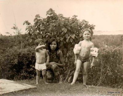 With Sue, our Amah in our garden
With Sue, our Amah in our garden, showing the jungle behind.
Keywords: Lucy Childs;Amah