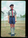 Stuart in the garden of Chempaka Kuning looking smart in his Air Scout uniform