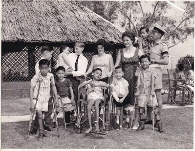 Official Opening of the new classroom
Taken on the same day, presumably the â€˜official openingâ€™ of the new classroom.
So sad that the names of the children are not written on the reverse but the back row, from the left as you look at it
Billy Ferguson, me, Edward Ferguson (holding â€˜Babyâ€™), Lorna Ferguson (my Aunt), Peggy Ferguson (my mother) and my father, Flt/Sgt W S Ferguson.
My father was awarded the BEM while in Singapore but I think it related to his work elsewhere.
Keywords: Edward Ferguson