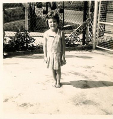 Photo of me as a young girl wearing the RAF Seletar infant school  uniform - Green and white check summer dress
Keywords: Sandra Chidgey