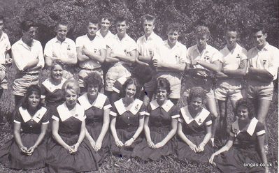 Prefects of ASM
Prefects of ASM, but some people are missing, perhaps not at school that day.  One male is half cut out of the picture.  I recognise ALL the faces but am stuck on names.

Here are those I know:  After the half out lad is me, Jim Parker, then Alan Smith the fifth Dave Carr, then third from the right is John McLoughlin.

Girls:  The fifth (and more or less central) figure is Valmay Gascoigne (now Young) who told me she and a friend designed the girls Prefectâ€™s uniform.  The second to last girl is Rowena Cross (who had beautiful curly ginger hair).

Me and other boy prefects fought a battle to be allowed to wear, as prefects, long trousers.  So this picture was taken before that.
