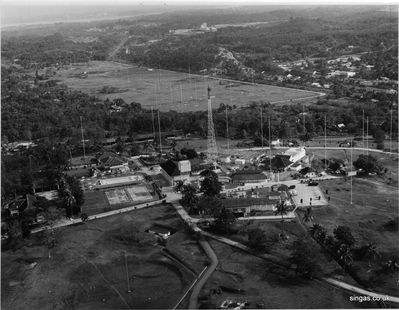 An aerial shot of RNWS Kranji -  taken from a southerly direction
This is taken from a southerly direction, showing WRNS Kranji with the aerial field behind and the Jurong Straits on the horizon. To the right of the aerial field is the straight "Woodlands Road", then the railway and Yew Tee Village. My father thinks the road rising north from Yew Tee was the Bukit Timah Road.
Keywords: Lucy Childs;RNWS Kranji;Yew Tee Village;Jurong Straits;Woodlands Road;Bukit Timah Road