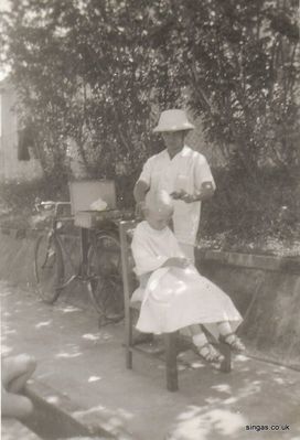 Michael Upfield having haircut
My brother Michael Upfield,
having his haircut in our garden  at 72 Braemar Drive Serangoon.
The photograph was taken around 1961-1964.
Keywords: Maureen Upfield;Michael Upfield;72 Braemar Drive;Serangoon;1961