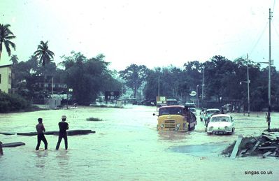 Bukit Timah Road would often flood
Bukit Timah Road would often flood, especially when the monsoon rains coincided with the tide coming up from the sea. Enterprising Singaporeans would offer to 'push out' vehicles that became stationary in the floodwater, making sure they pushed your exhaust pipe beneath it, ensuring a handsome tip from grateful motorists!
Keywords: Bill Johnston;Bukit Timah Road;monsoon;flood