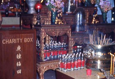 Vesak
The altar.  If I remember correctly those bottles of holy water were actually F&N (Fraser and Neave) pop bottles!  (I think F&N was an Australian company)
Keywords: Vesak;temple