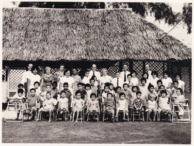 1963 involved in building a classroom
My father, Flt/Sgt W S Ferguson (Billy) and others including  from the Provost Branch â€“ RAF Military Police â€“ were involved sometime around 1963 in building a classroom.  As far as I recall it was a school or home for children with disabilities and it wasnâ€™t too far from the Changi base. Unfortunately I cannot remember the name of the place.  I was a little involved as a 13 year old in volunteering to help with some of the children and I remember the matron in charge as being a lovely lady but thatâ€™s about it..... anyway here are a few of the photos I found related to there.....The matron is back row, 8th adult from the right.  Iâ€™m Edward and Iâ€™m standing beside her to her left and to my left is my younger brother, Billy
Keywords: Edward Ferguson;RAF Changi;1963