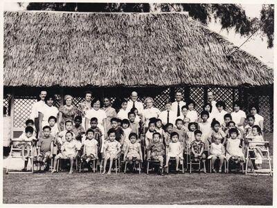 1963 involved in building a classroom
My father, Flt/Sgt W S Ferguson (Billy) and others including  from the Provost Branch â€“ RAF Military Police â€“ were involved sometime around 1963 in building a classroom.  As far as I recall it was a school or home for children with disabilities and it wasnâ€™t too far from the Changi base. Unfortunately I cannot remember the name of the place.  I was a little involved as a 13 year old in volunteering to help with some of the children and I remember the matron in charge as being a lovely lady but thatâ€™s about it..... anyway here are a few of the photos I found related to there.....The matron is back row, 8th adult from the right.  Iâ€™m Edward and Iâ€™m standing beside her to her left and to my left is my younger brother, Billy
Keywords: Edward Ferguson;RAF Changi;1963