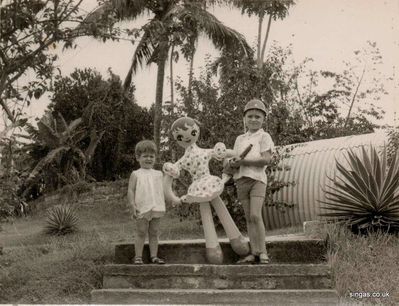 On the steps down to our bungalow, Singapore.
Keywords: Lucy Childs