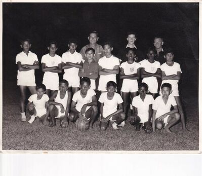 "Young Malaysiaâ€ football team
My father was a keen footballer and became involved in working with young people and the "Young Malaysiaâ€ football team.  Sadly there are no names on the reverse of the photo but someone may recognise these young people and their coaches  ........ this photograph is dated on the reverse 18th August 1964.
Keywords: Edward Ferguson;RAF Changi;1964