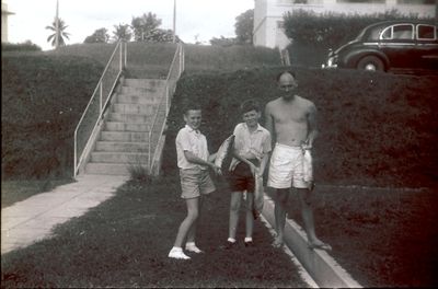 Alan, Terry (me) and our father, after a great day's fishing. The old man's Wolsley 6/80 is parked above.
