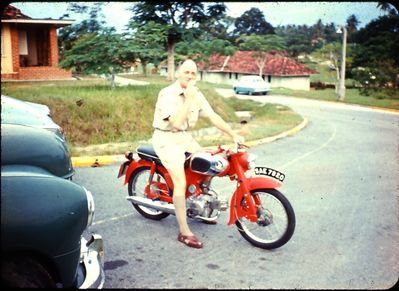 Lloyd Leas. The old man smoking (like all aircrew, as usual) on his Honda 50. He loved the little bike, and rode it everywhere ... even though he had some great cars too. Preferred it to his Mercedes.
