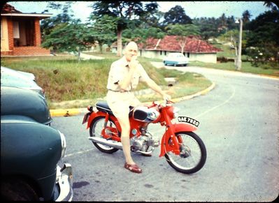 Lloyd Leas. The old man smoking (like all aircrew, as usual) on his Honda 50. He loved the little bike, and rode it everywhere ... even though he had some great cars too. Preferred it to his Mercedes.
