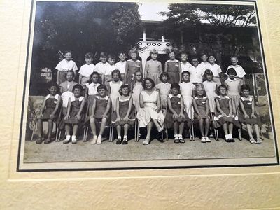 my name is peter staines this photo was taken some time between 1957 -60 i am second from the right in the back row .the teachers name was mrs brown ,i was in montgomery house we had a green sheild i remember first post hope it works 
