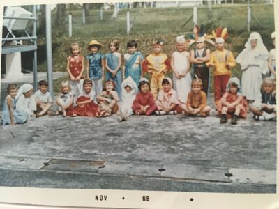 Back row standing myself with the red silk tunic, 4th from left Margo Fairbairn wearing the sari, extreme right and half cut out from the picture Sally Ann Walker wearing a patriotic costume
