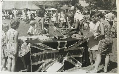 Sports Day 1969
Mrs Curran with her back to the camera wearing the flowery dress. Judy Forrester in the polka dot dress. Mrs McNamara (Head teacher) wearing the plain dress and sun glasses talking to Judy. My friend Sally Ann Walker collecting her prize with myself behind her. 
