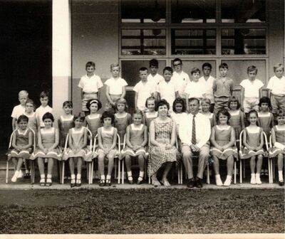 My brother Donny Payne outside in a class photo.  Heâ€™s standing directly behind the female teacher not too long after we arrived so probably late 62/early 63,
Keywords: Donny Payne;1962;Pasir Panjang;junior school
